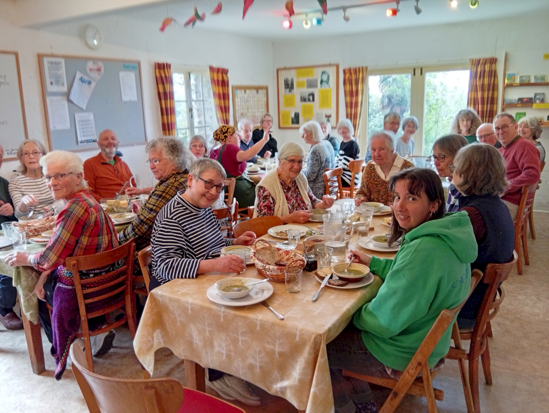 People having lunch on several tables looking up and smiling